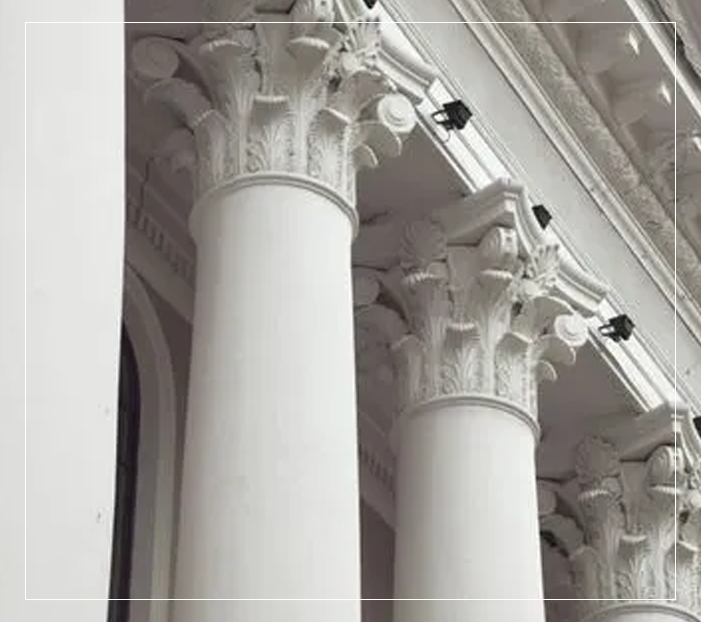 A close up of two pillars with security cameras on them.